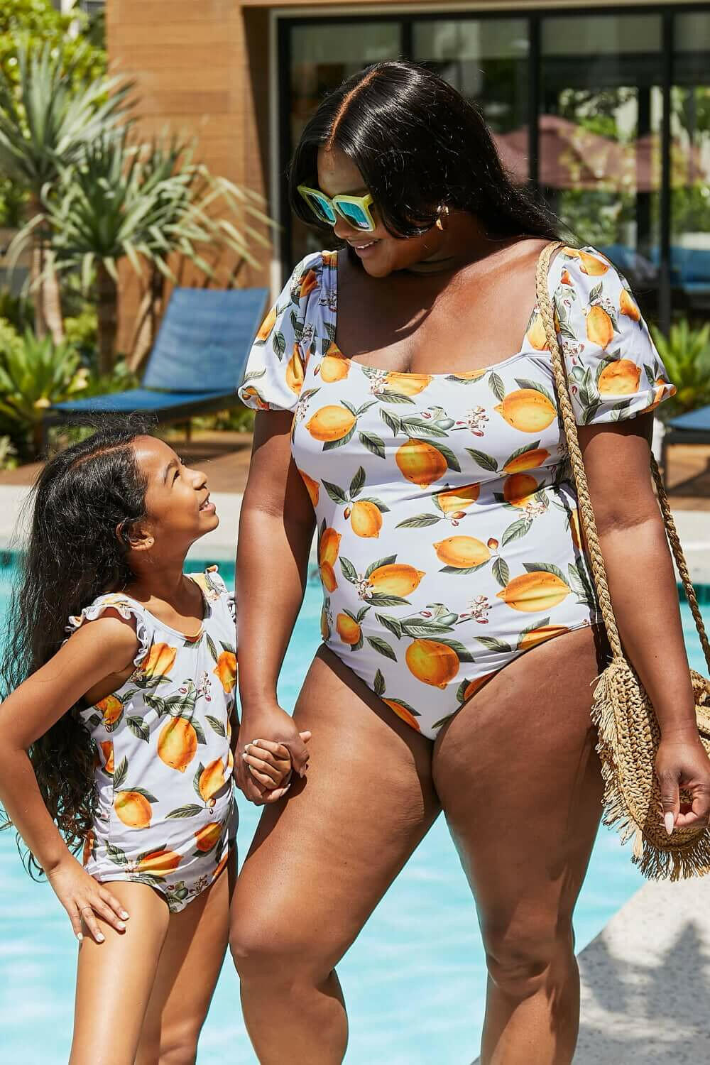 Marina West Swim Float On Ruffled One-Piece in Citrus Orange.